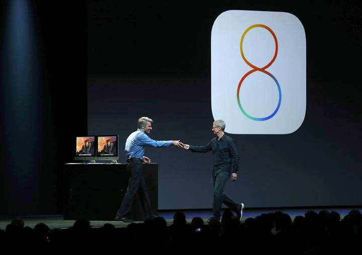 Senior Vice President of Software Engineering Craig Federighi greets Apple CEO Tim Cook on stage.