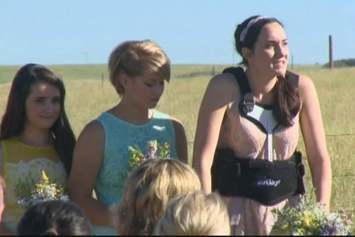 Maid of honour Marilyn Kruc in a back brace during wedding ceremony.