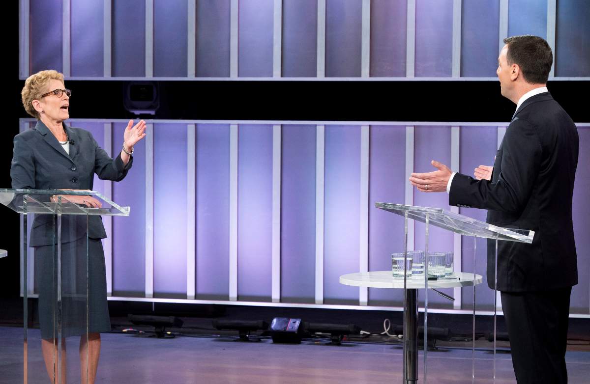 Ontario Premier Kathleen Wynne, left, and Ontario PC leader Tim Hudak take part in the live leaders debate at CBC during the Ontario election in Toronto on Tuesday, June 3, 2014. 