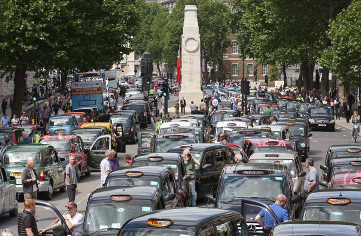 Taxis blockade Whitehall on June 11, 2014 in London, England. London's licensed black taxi drivers are campaigning against the introduction of the 'Uber' taxi smartphone app in the United kingdom.