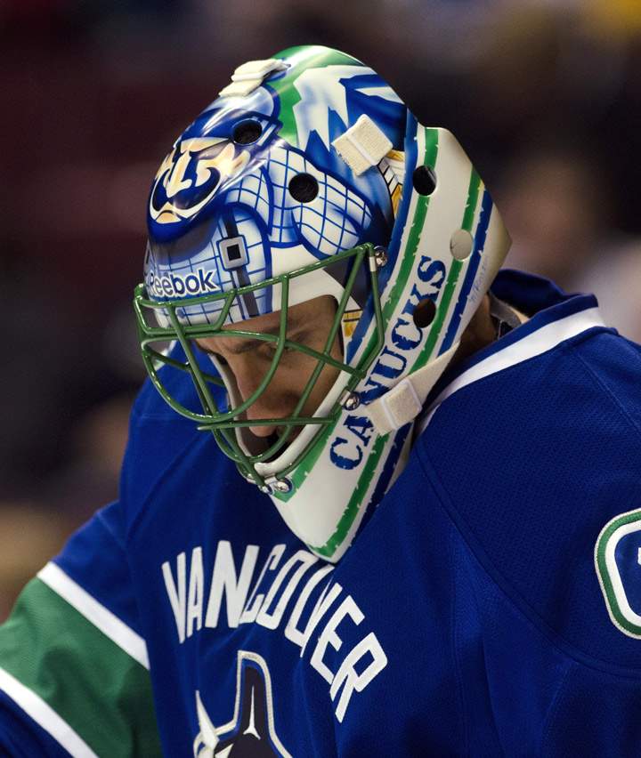 Goalie Roberto Luongo #1 of the Vancouver Canucks wears his new mask during a break in the play against the Nashville Predators in NHL action on October 20, 2011 at Rogers Arena in Vancouver, British Columbia, Canada.