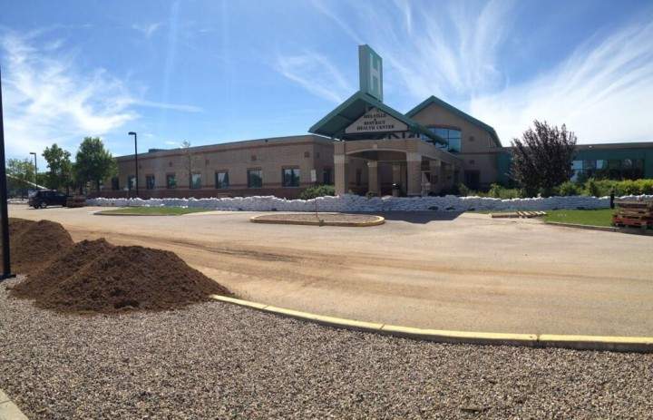 Sandbags are piled in front of the Melville & District Health Centre.