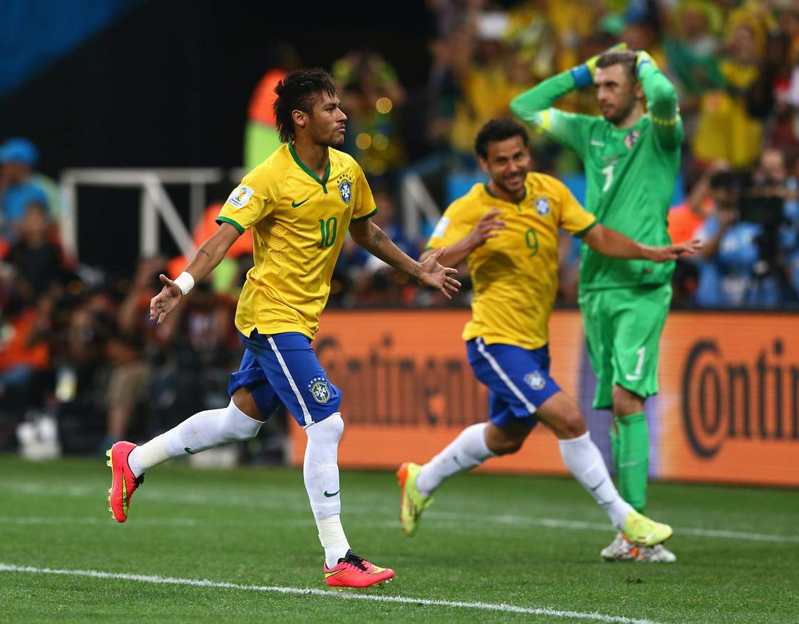 Neymar of Brazil scores on a penalty kick to give the host nation a win to open the tournament.