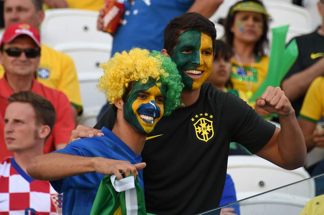Brazilian fans cheer before a Group A football match between Brazil and Croatia at the Corinthians Arena in Sao Paulo on June 12, 2014 prior to the opening match of the 2014 FIFA World Cup. AFP PHOTO / VANDERLEI ALMEIDA (Photo credit should read VANDERLEI ALMEIDA/AFP/Getty Images)