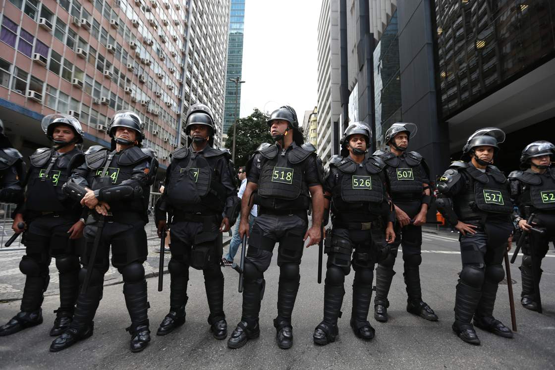 RIO DE JANEIRO, BRAZIL - JUNE 12: A line of police stand guard during an anti-World Cup demonstration on June 12, 2014 in Rio de Janeiro, Brazil. This is the first day of World Cup play. (Photo by Joe Raedle/Getty Images)