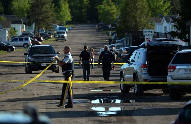 RCMP investigators work at the home of shooting suspect Justin Bourque in Moncton, N.B. on Sunday, June 8, 2014.