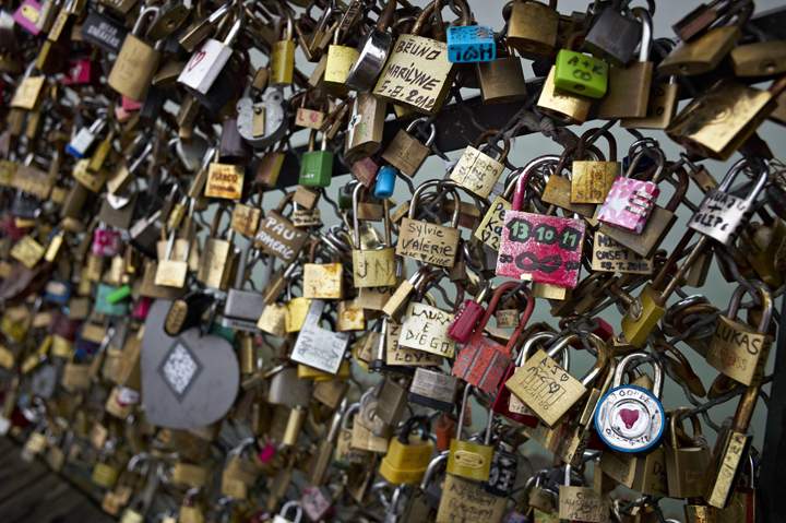 Padlocks adorn the railing of the Pont des Arts pedestrian bridge over the river Seine in Paris, France, Thursday, April 4, 2013.