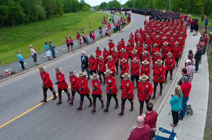 RCMP officers march in the funeral procession on their way to the regimental funeral for three slain RCMP officers in Moncton, N.B., Tuesday, June 10, 2014.
