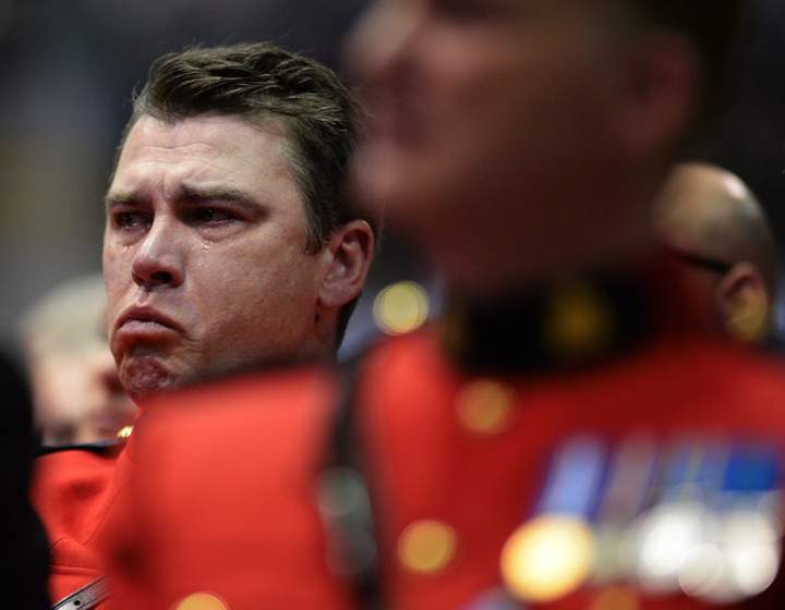 An RCMP officer tries to contain his emotions at the RCMP regimental funeral on Tuesday, June 10, 2014 for the three RCMP officers who were gunned down in Moncton last week.