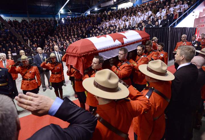 The casket of Const. Douglas James Larche, is carried into the Moncton Coliseum for the RCMP regimental funeral on Tuesday, June 10, 2014, in Moncton, N.B.