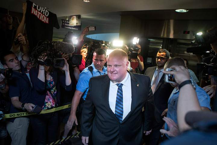 Toronto Mayor Rob Ford is greeted by a media throng as returns to his office at city hall in Toronto on Monday June 30, 2014,