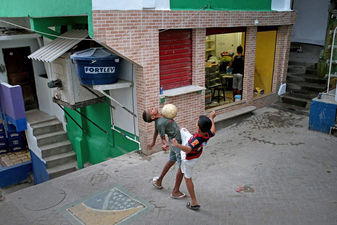 RIO DE JANEIRO, BRAZIL - JUNE 08: Children play a game of soccer in the streets of a 'favela' called Santa Marta on June 8, 2014 in Rio de Janeiro, Brazil. Brazil continues to prepare to host the World Cup which starts on June 12th and runs through July 13th. (Photo by Joe Raedle/Getty Images)