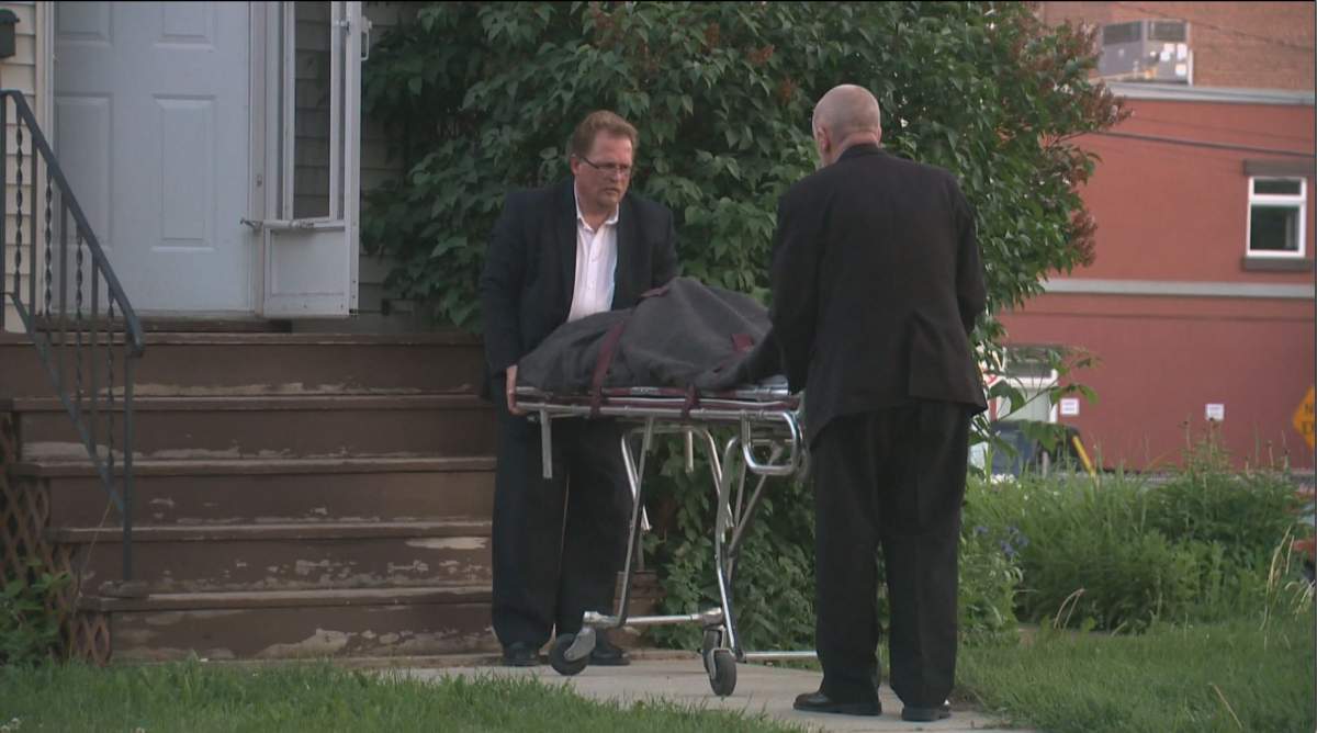 A man’s body is removed from a home in Edmonton’s Bonnie Doon neighbourhood. June 22, 2014.
