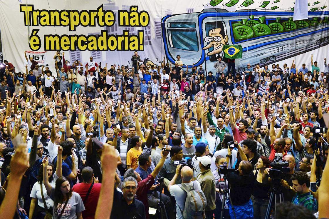 Metro workers meeting at their union headquarters in Sao Paulo, Brazil on June 11, 2014, raise their hands to vote the end of their strike, on the eve of the opening match of the FIFA World Cup 2014. AFP PHOTO / NELSON ALMEIDA (Photo credit should read NELSON ALMEIDA/AFP/Getty Images)
