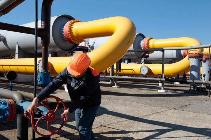 FILE - In this Wednesday May 21, 2014 file photo, a Ukrainian worker operates a valve in a gas storage point in Bil 'che-Volicko-Ugerske underground gas storage facilities in Strij, outside Lviv, Ukraine. Russia on Monday, June 16, 2014, cut gas supplies to Ukraine as a payment deadline passed and negotiators failed to reach a deal on gas prices and unpaid bills amid continued fighting in eastern Ukraine. The decision does not immediately affect the gas flow to Europe, but could disrupt the long-term energy supply to the region if the issue is not resolved, analysts said. 