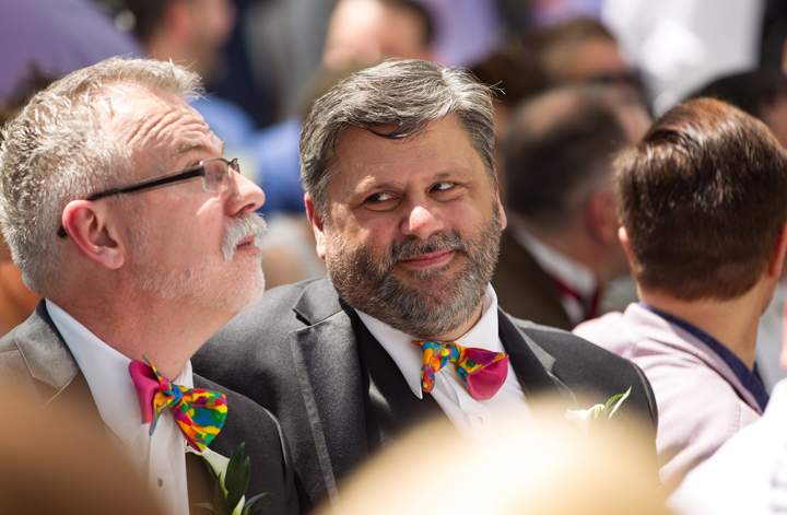 A man smiles at his fiance during the Grand Pride Wedding on June 26, 2014.