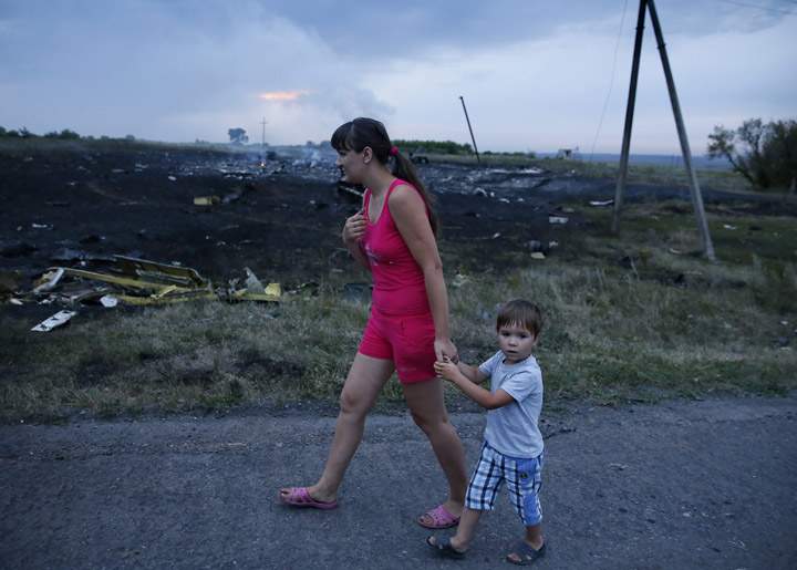 People walk near the site of the crash.