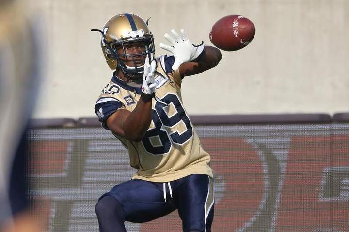 Clarence Denmark warms up before the start of a CFL game against the Hamilton Tiger-Cats in 2014.
