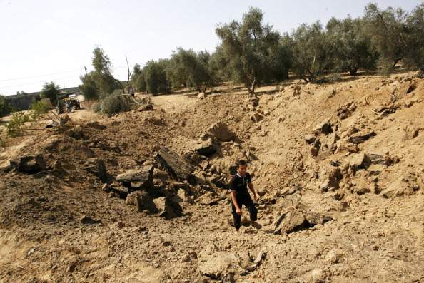 A Palestinian inspects the site of an Israeli air strike in Khan Yunis in the southern Gaza Strip. Israeli aircrafts attacked 10 sites used by Palestinian militants in the Gaza Strip on Sunday in response to persistent rocket strikes from the enclave. (Photo by Abed Rahim Khatib/Pacific Press/LightRocket via Getty Images).