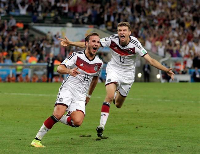 Germany's Mario Goetze (19) celebrates with Thomas Mueller after scoring his side's first goal in extra time.