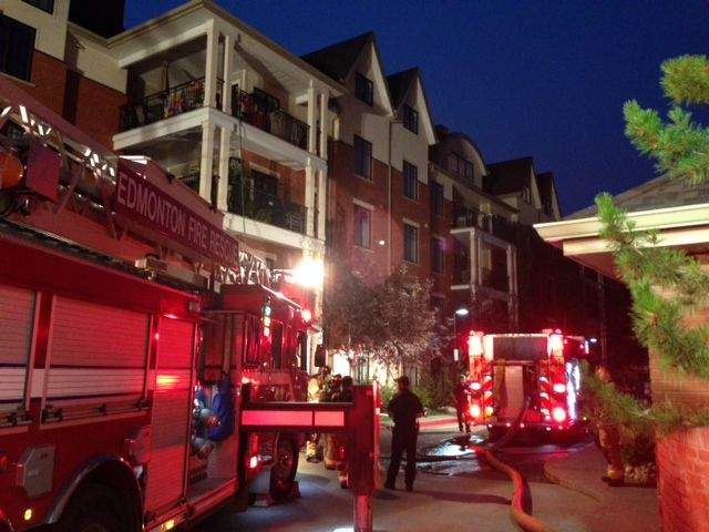 Fire crews battle a fire in a Edmonton condo building, Thursday, July 17, 2014. 