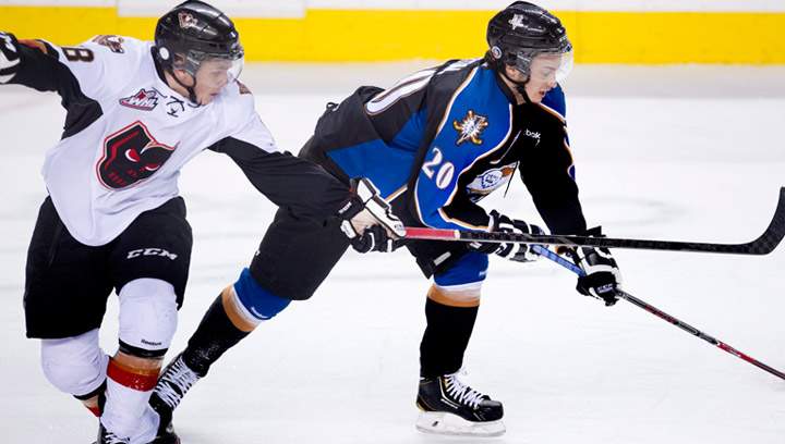 Kootenay Ice's Tim Bozon, right, playing against Calgary Hitmen's Jake Virtanen during a game in Calgary on December 30, 2013. Bozon, who was diagnosed with Neisseria meningitis on March 1 after playing a WHL game in Saskatoon, is back on the ice and set to play for France at an under-23 tournament.