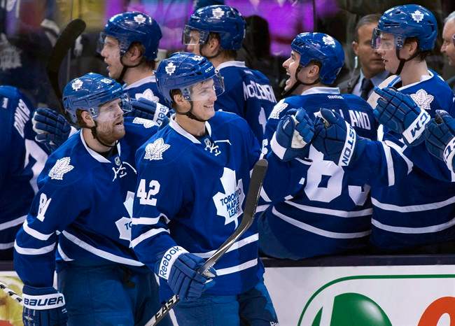 Toronto Maple Leafs Tyler Bozak (42) is congratulated on his goal along with teammate Phil Kessel (left) for the assist against the Boston Bruins during first period NHL action in Toronto on Thursday April 3, 2014.