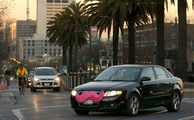 A Lyft car crosses Market Street in San Francisco on Jan. 17, 2013.