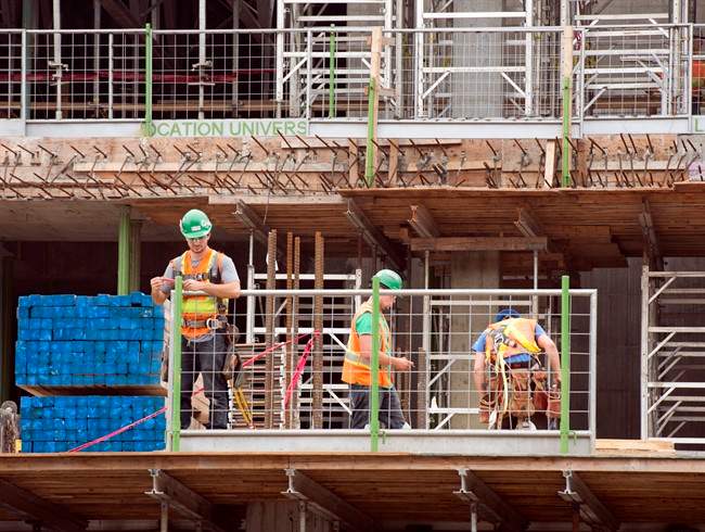 Construction workers are picture in Montreal.