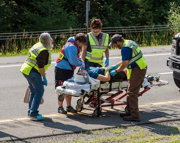 Emergency personnel attend to a victim after a bus accident on Interstate 87, also known as the Adirondack Northway, in North Hudson, N.Y. on Friday July 18, 2014.