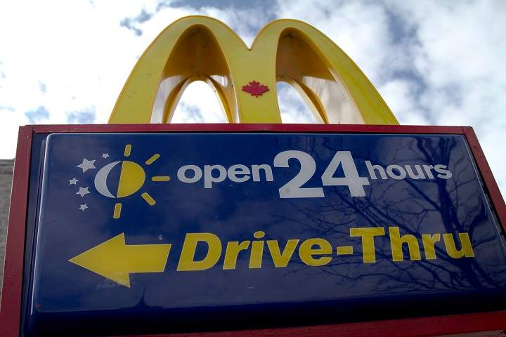 A 24-hour drive-thru sign outside a McDonald's restaurant.