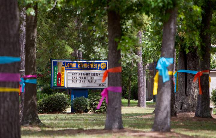 Ribbons are tied around trees in front of Lemm Elementary School in Spring, Texas on Thursday, July 10, 2014.