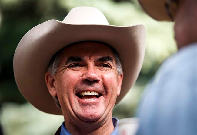 Alberta PC Party leadership candidate Jim Prentice talks with constituents at a Stampede breakfast in Calgary, Alta., Monday, July 7, 2014. THE CANADIAN PRESS/Jeff McIntosh.