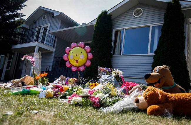 Flowers and teddy bears are shown at an impromptu memorial for Nathan O’Brien and his grandparents, Alvin and Kathryn Liknes, at the Liknes home in Calgary, Alta., Tuesday, July 15, 2014.