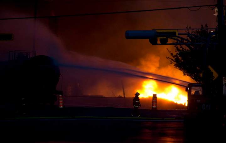 Fire keeps burning nearly 24 hours after railway cars that were carrying crude oil derailed in downtown Lac-Mégantic, Que., Saturday, July 6, 2013.