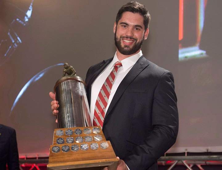 Laurent Duvernay-Tardif, of the McGill University Redmen, receives the J.P. Metras Trophy as the Outstanding Down Lineman during Vanier Cup celebrations Thursday, November 21, 2013 in Quebec City.