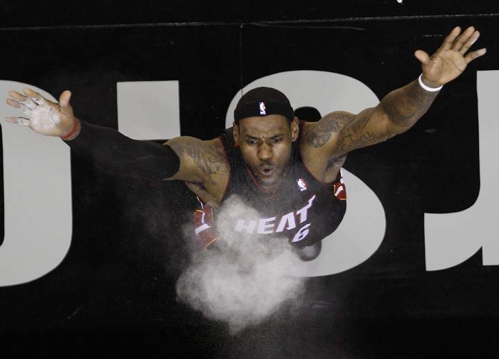 Miami Heat’s LeBron James throwing powder into the air prior to the team’s NBA preseason basketball game against the San Antonio Spurs, in San Antonio. AP Photo/Eric Gay/File