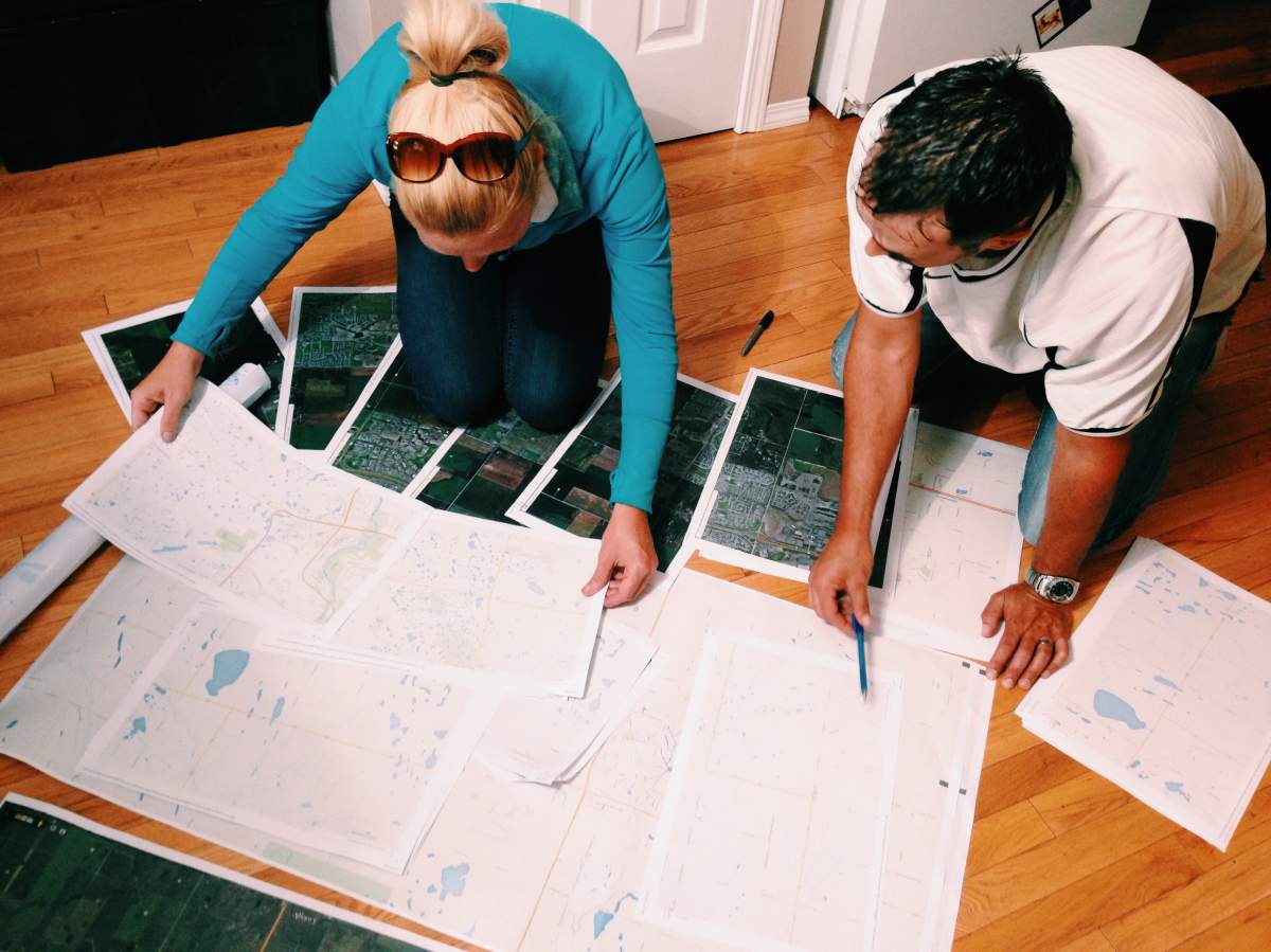 Matt Forseth and Laura Cameron look at maps as they organize a search near Airdrie.