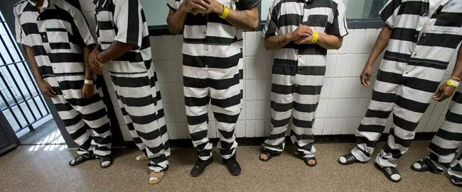 Inmate at the Saginaw County Jail, wear the new black and white jumpsuits Friday, July 18, 2014 in Saginaw, Mich. The Saginaw County Sheriff's Department has purchased the striped jumpsuits for some of the inmates at the jail.