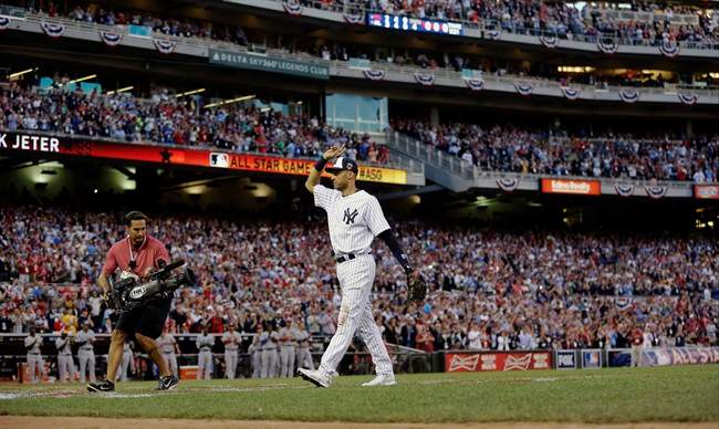 American League shortstop Derek Jeter, of the New York Yankees, waves as he is taken out of the game in the top of the fourth inning of the MLB All-Star baseball game, Tuesday, July 15, 2014, in Minneapolis.