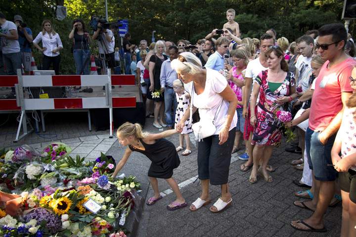 Mourners lay flowers at the entrance of the Korporaal van Oudheusdenkazerne, a military establishment where the bodies of the downed Malaysia Airlines flight MH17 will be examined and identified on July 23, 2014 in Hilversum.