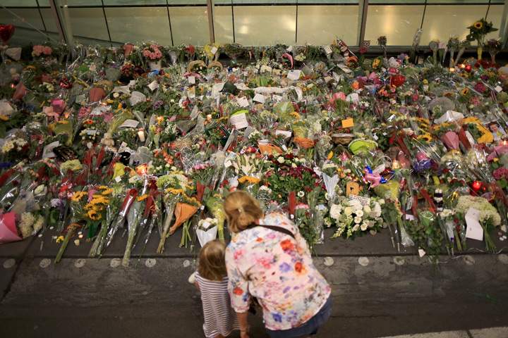 A woman and a child view the tributes at the entrance to Schiphol Airport which has grown into a sea of flowers in memory of the victims of Malaysia Airlines flight MH17 on July 20, 2014 in Amsterdam, Netherlands.