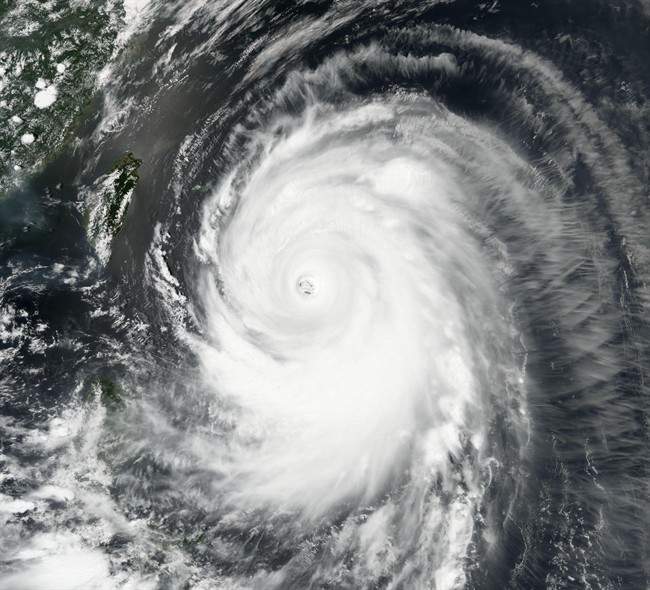 In this image provided by NASA, Typhoon Neoguri churns toward Okinawa and southern Japan on Tuesday, July 8, 2014.