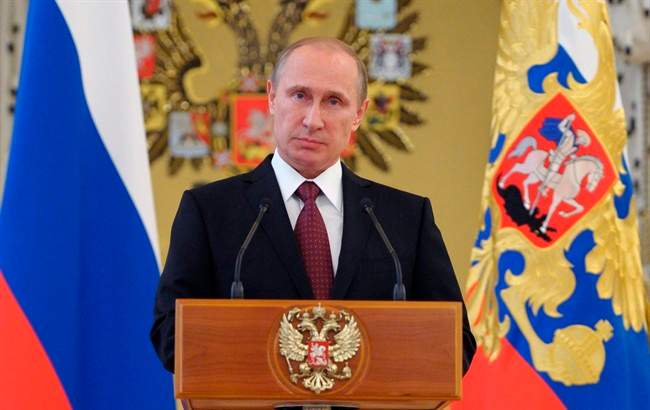 FILE - In this June 26, 2014, file photo, Russian President Vladimir Putin addresses graduates of military academies in Moscow's Kremlin.