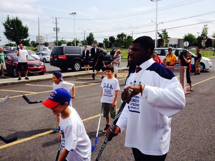 P.K. Subban plays road hockey with youths in Brossard, to promote accessible hockey for all.