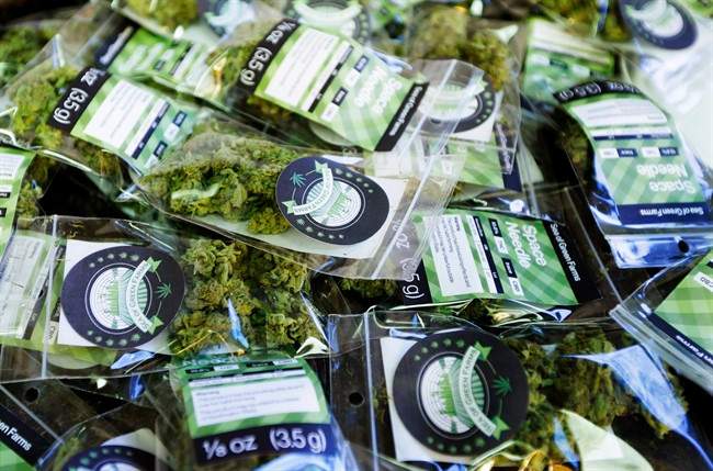 In this photo taken Tuesday, July 1, 2014, packets of a variety of recreational marijuana named “Space Needle” are shown during packaging operations at Sea of Green Farms in Seattle. The grower, the first business licensed to grow recreational marijuana in Washington state, worked all weekend to have supplies ready for stores that were expected to be granted sale licenses on Monday, July 7, the day before legal recreational pot sales begin on July 8.