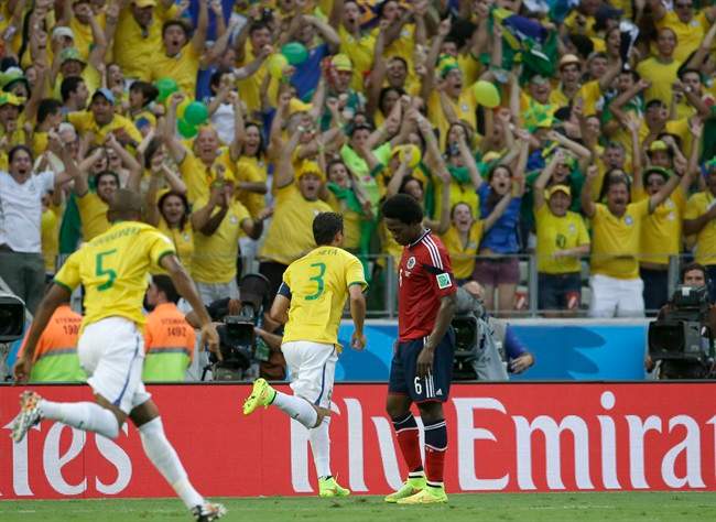 Brazil's Thiago Silva, center, celebrates after scoring the opening goal during the World Cup quarterfinal soccer match between Brazil and Colombia at the Arena Castelao in Fortaleza, Brazil, Friday, July 4, 2014.