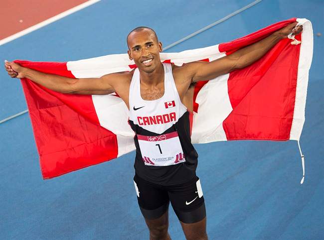 Canada's Damian Warner displays the flag after winning the gold medal in decathlon at Hampden Park at the Commonwealth Games in Glasgow, Scotland on Tuesday, July 29, 2014. Canada finished third in the overall medal count.