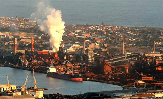 Smoke billows out of a chimney stack of steel works factories in Port Kembla, south of Sydney.