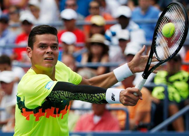 Milos Raonic, of Canada, returns a shot against Victor Estrella Burgos, of Dominican Republic, during the third round of the 2014 U.S. Open tennis tournament, Saturday, Aug. 30, 2014, in New York. (AP Photo/Kathy Willens).